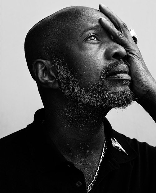 david mcalmont with his hand over part of  his face